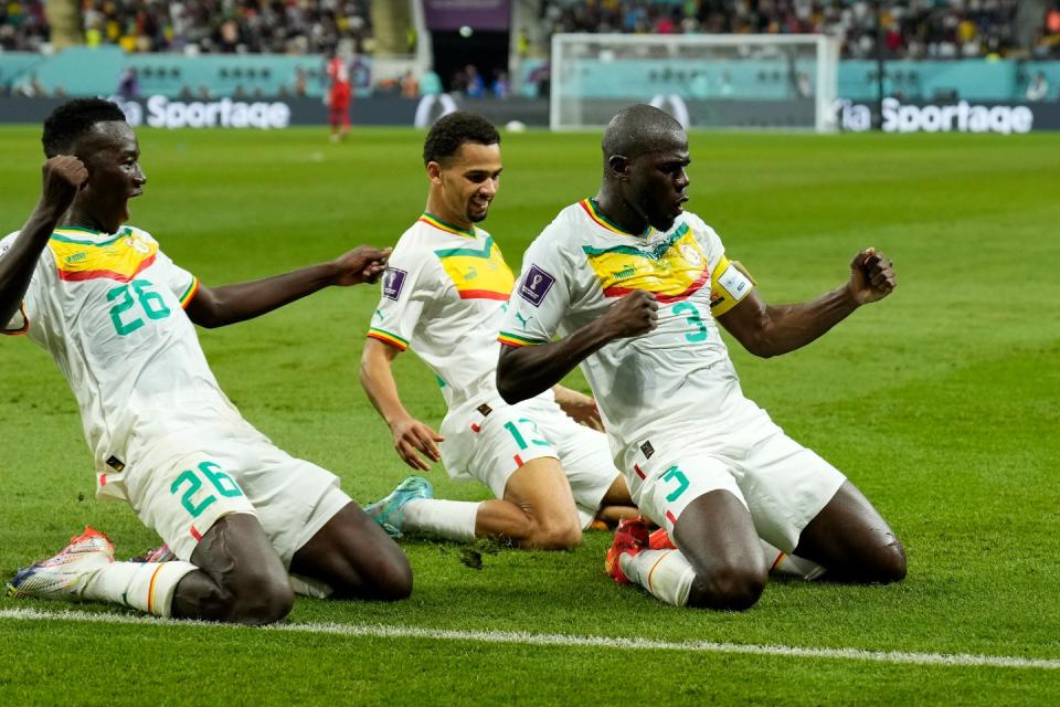 Senegal's Kalidou Koulibaly, right, celebrates with teammates scoring his side's second goal during the World Cup group A football match between Ecuador and Senegal, at the Khalifa International Stadium in Doha, Qatar, Tuesday, Nov. 29, 2022. (AP Photo/Francisco Seco)