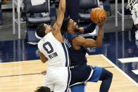 Minnesota Timberwolves' Malik Beasley, right, drives to the basket as Memphis Grizzlies' De'Anthony Melton defends in the second half of an NBA basketball game, Wednesday, Jan. 13, 2021, in Minneapolis. The Grizzlies won 118-107. Beasley led the Timberwolves with 28 points. (AP Photo/Jim Mone)