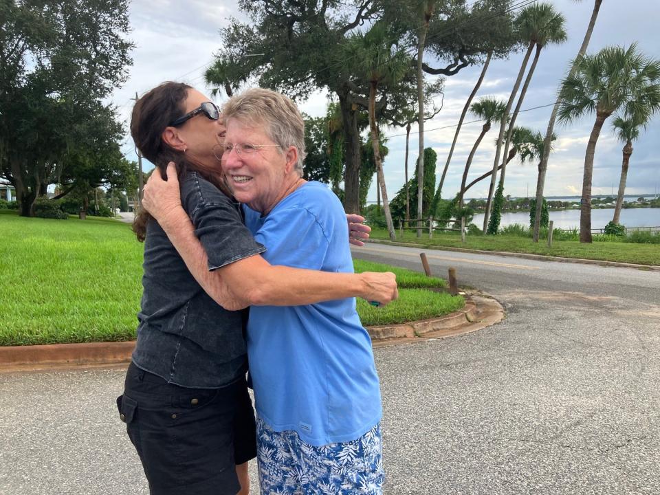 Former River Heights neighbors Dina Franklin, left, and Karen Wald share a hug after the scrub of the Artemis I mission Monday.