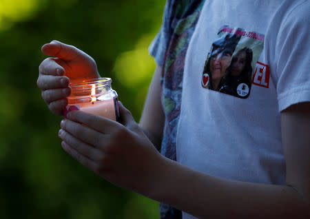 A boy carries a candle during a vigil for the victims of an attack on concert goers at Manchester Arena, in Royton, near Manchester, Britain May 26, 2017. REUTERS/Phil Noble