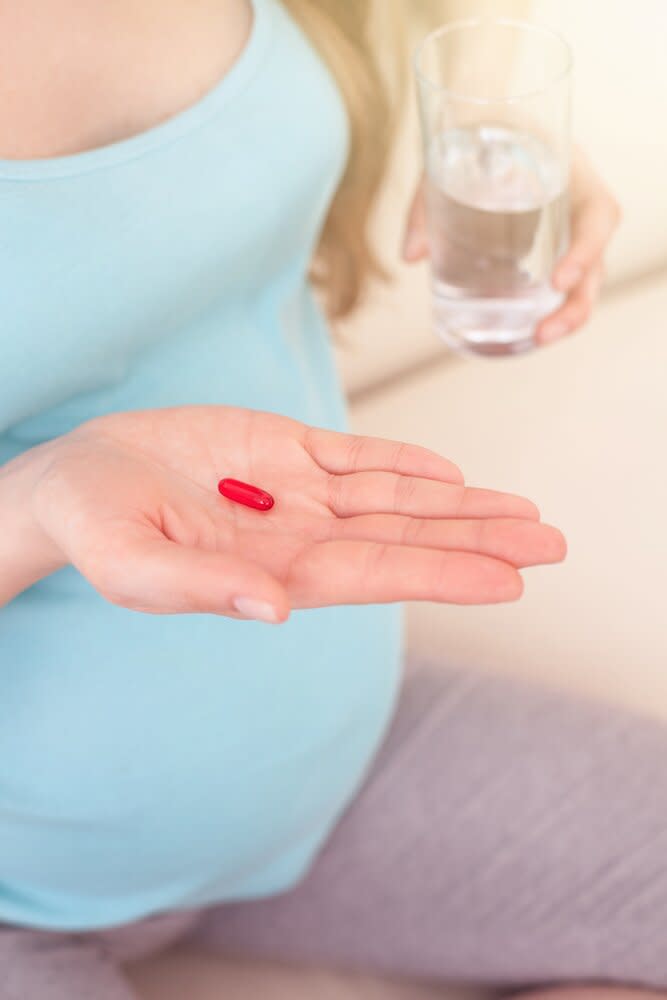 Pregnancy Stress Quiz Holding Pills Blue Shirt