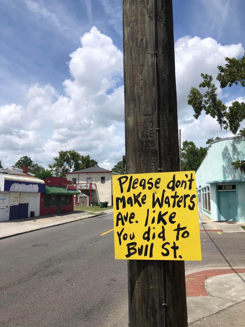 Local artist Panhandle Slim posted these sings to Waters Avenue after the announcement of a new café triggered fears of gentrification and displacement for the local community on the Eastside.