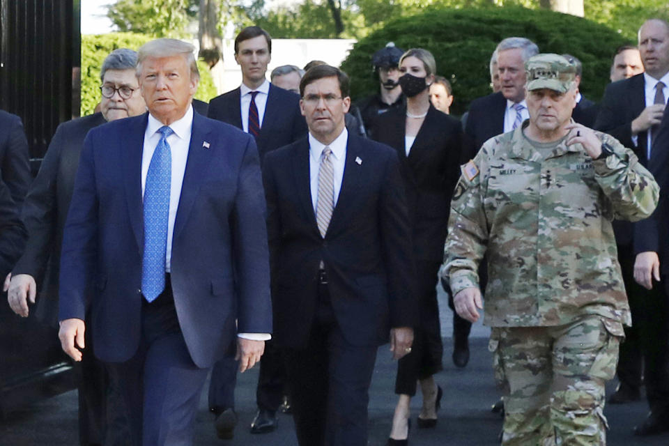 FILE - In this June 1, 2020 file photo, President Donald Trump departs the White House to visit outside St. John's Church, in Washington. Walking behind Trump from left are, Attorney General William Barr, Secretary of Defense Mark Esper and Gen. Mark Milley, chairman of the Joint Chiefs of Staff. Milley put his own job on the line by apologizing for being part of the entourage that accompanied Trump to a photo op outside a church near the White House after peaceful protesters were forcibly removed from the area. (AP Photo/Patrick Semansky, File)