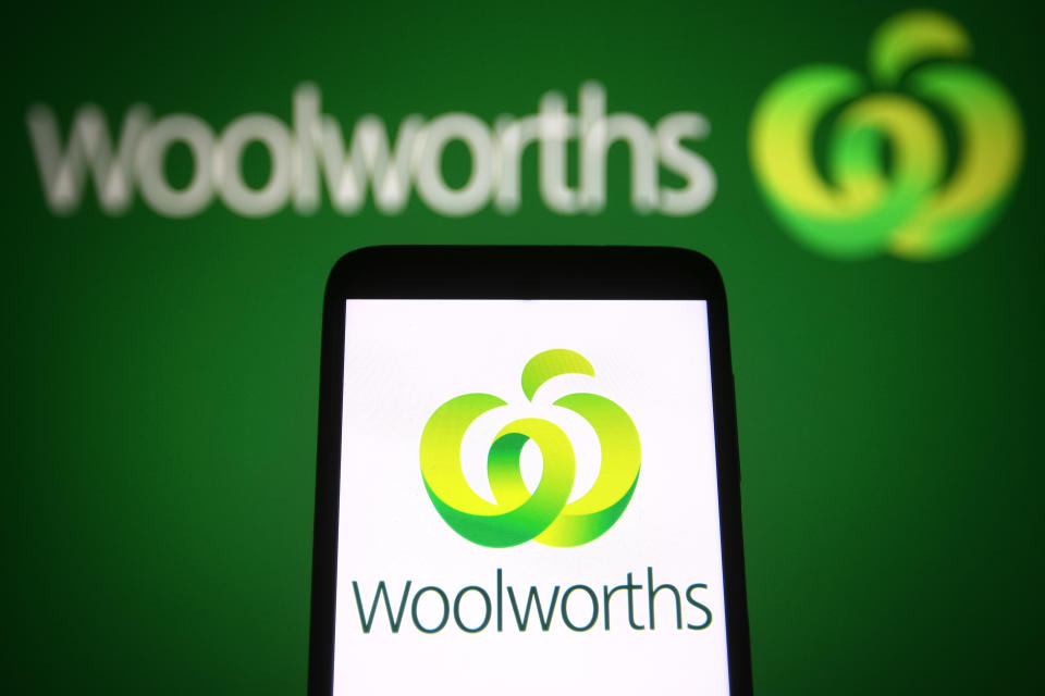 Woolworths icon on phone in front of Woolworths storefront logo. Source: Getty Images