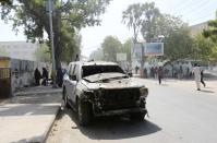 The wreckage of a car destroyed in a blast is seen near the Central Hotel after a suicide attack in Somalia's capital Mogadishu February 20, 2015. Islamist rebels detonated a car bomb at the entrance of the hotel in the Somali capital on Friday and then stormed inside where politicians had gathered, killing at least 10 people including a lawmaker and lightly wounding two ministers. (REUTERS/Feisal Omar)