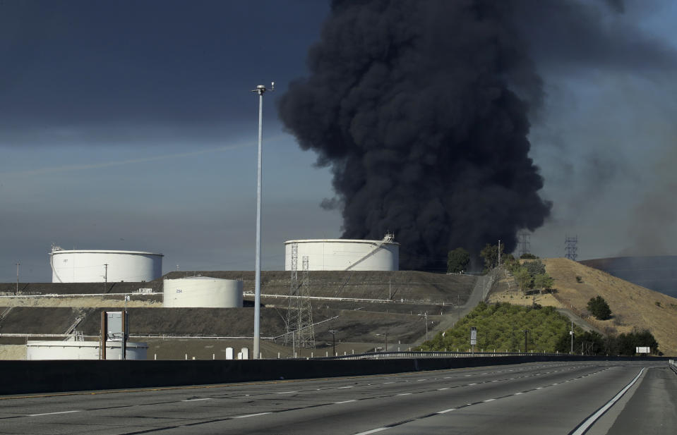 Interstate 80 is closed as a fire at an oil storage facility burns Tuesday, Oct. 15, 2019, in Crockett, Calif. A fire burning at NuStar Energy LP facility prompted a hazardous materials emergency that led authorities to order the residents of two communities, including Rodeo, to stay inside with all windows and doors closed. "This is a very dynamic, rapidly evolving situation," Capt. George Laing of the Contra Costa Fire Department said. (AP Photo/Ben Margot)