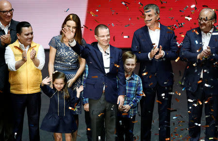 Ricardo Anaya, accompanied by his family and members of the parties that took part in the left-right coalition, gestures after being sworn-in as presidential candidate of the National Action Party (PAN) at the Auditorio Nacional in Mexico City, Mexico February 18, 2018. REUTERS/Edgard Garrido