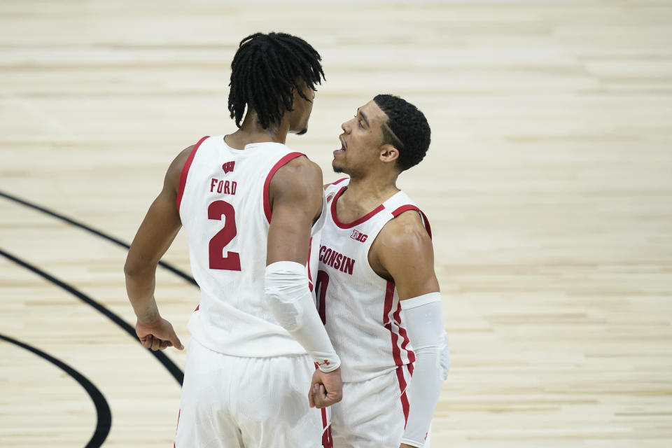 Wisconsin's Aleem Ford (2) celebrates with D'Mitrik Trice (0) after Ford hit a shot as time expired to end the first half of an NCAA college basketball game against Penn State at the Big Ten Conference tournament, Thursday, March 11, 2021, in Indianapolis. (AP Photo/Darron Cummings)