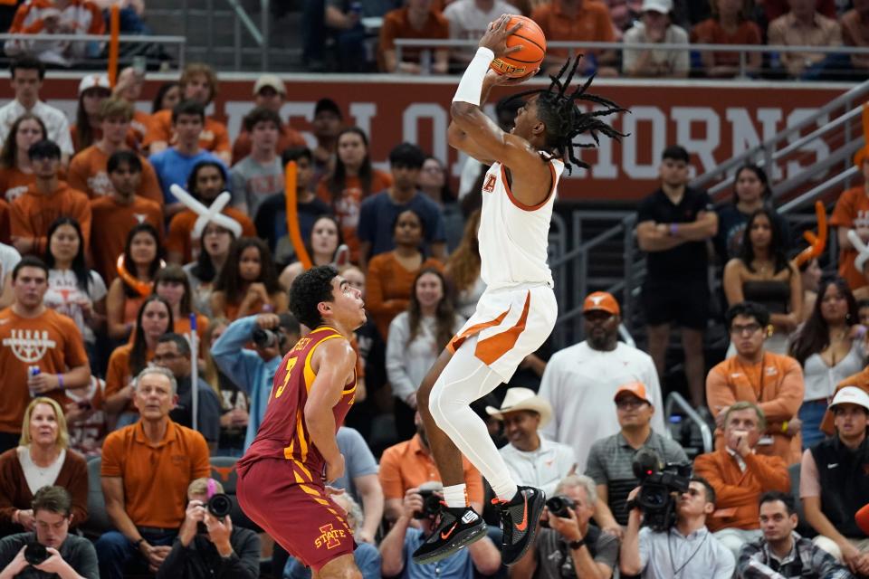 Texas guard Marcus Carr shoots over Iowa State guard Tamin Lipsey in the second half. Carr, who's Texas' leading scorer this season, hit three 3-pointers in the 72-54 win over the No. 23 Cyclones. "On any given night," UT interim coach Rodney Terry said, "we can play through any different guy."