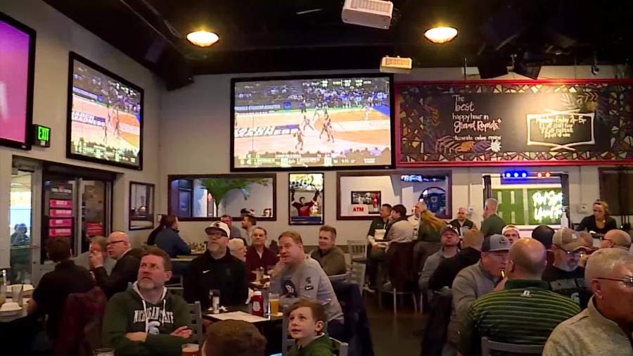 Basketball fans watch Michigan State play in the NCAA Tournament at The Score Restaurant & Sports Bar near Grand Rapids on March 21, 2024.