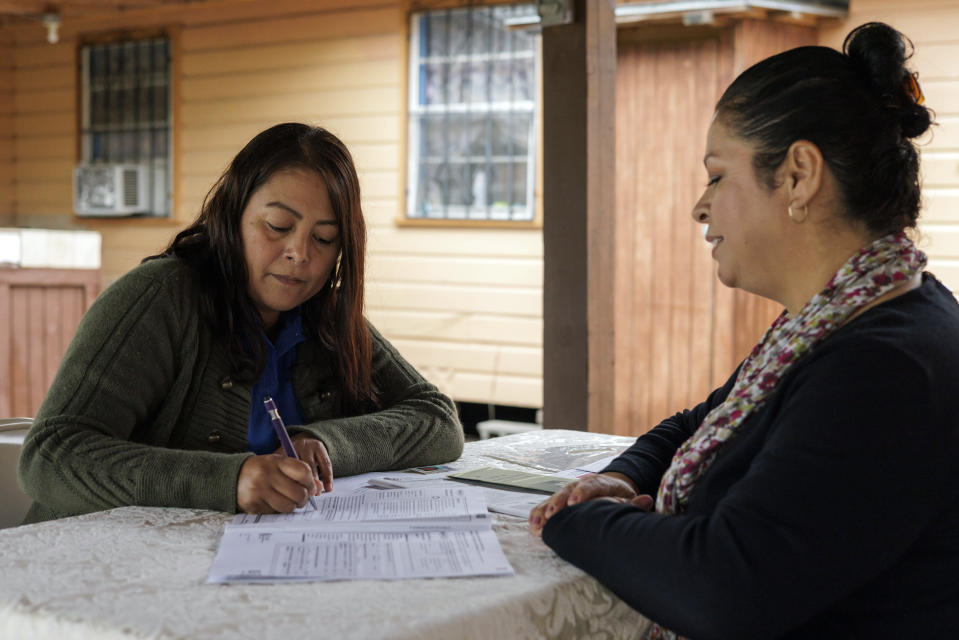 Children's Defense Fund program director Graciela Camarena assists Lucia Salazar with filling out Medicaid and SNAP application forms for her family in Pharr, Texas, Monday, Nov. 13, 2023. As the state reviews Texans' eligibility, some 1 million people have already lost Medicaid and organizations like the one Graciela works for assist people in applying again. (AP Photo/Michael Gonzalez)