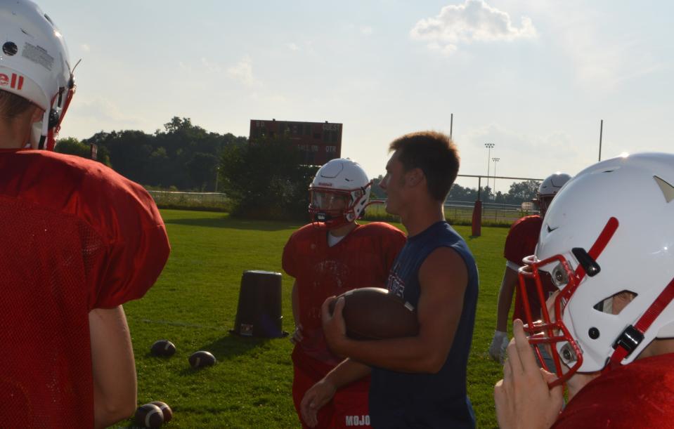 Nico Johnson talks with the skill position players during a practice for Britton Deerfield this summer.