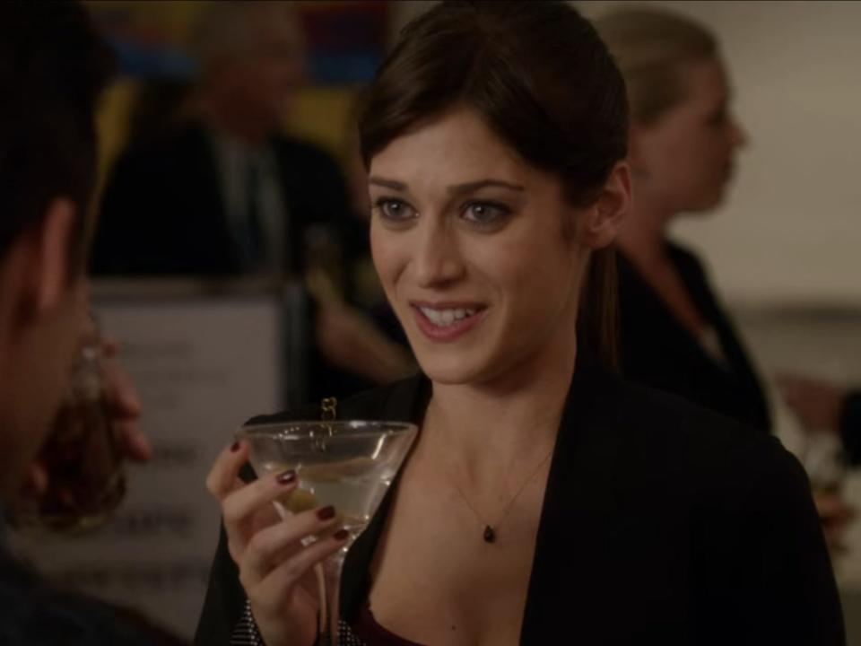 Lizzy Caplan holds a martini at a dinner party on the set of "New Girl"