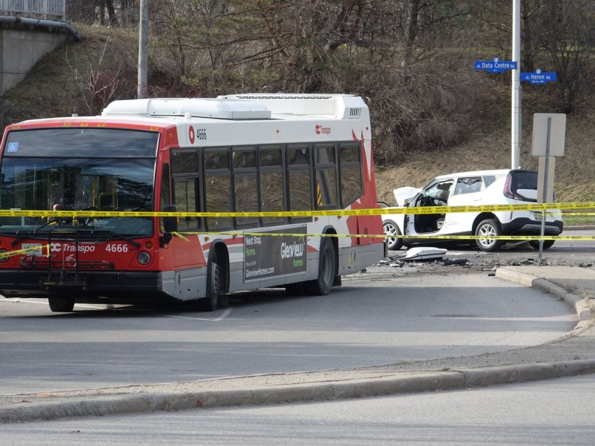 Ottawa police say the driver and passenger of the vehicle on the right were critically injured in a crash with an OC Transpo bus on Heron Road on April 21, 2023. (Francis Ferland/CBC - image credit)