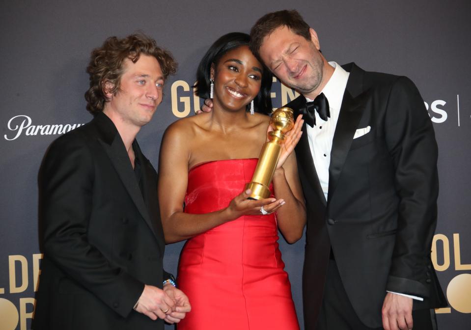 Ayo Edebiri (center) celebrates her Golden Globe win with "The Bear" co-stars Jeremy Allen White and Ebon Moss-Bachrach.