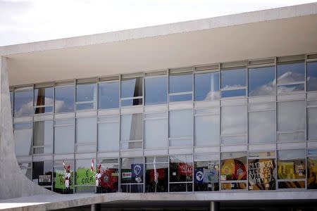 Posters placed by supporters of Brazilian President Dilma Rousseff are pictured at the Planalto Palace after a ceremony to announce the creation of new public universities, in Brasilia, Brazil, May 9, 2016. REUTERS/Ueslei Marcelino