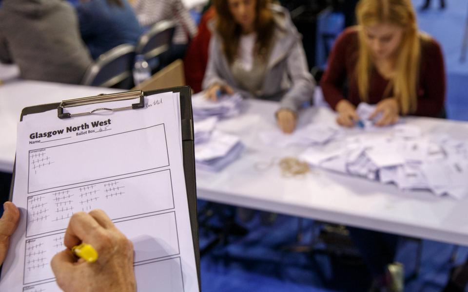 Election officials count votes in the Emirates Arena in Glasgow - Credit: EPA