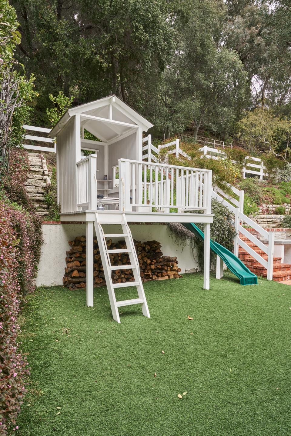 Wark’s pièce de résistance? An elevated playhouse for Arthur. “It’s raised up so that he can park his little trucks down below it,” Wark says. "It’s gotten a lot of use over the years, but I think I’m going to have to put an iPhone charger in there for him to go back in there now.” The staircase to the right leads to the property’s pool.