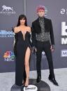 <p>The engaged couple wore coordinated black ensembles for the music event. Fox wore a silver flower-embellished David Koma black column dress with a thigh-high leg slit for the occasion, while Kelly sported a cropped suit jacket and trousers - both covered with spikes on the seams.</p><p>Fox styled her black hair in a sleek straight do and added a fringe.</p>