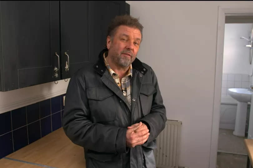 Homes Under the Hammer presenter, Martin Roberts in the kitchen of the two-bed mid-terrace in Stoke