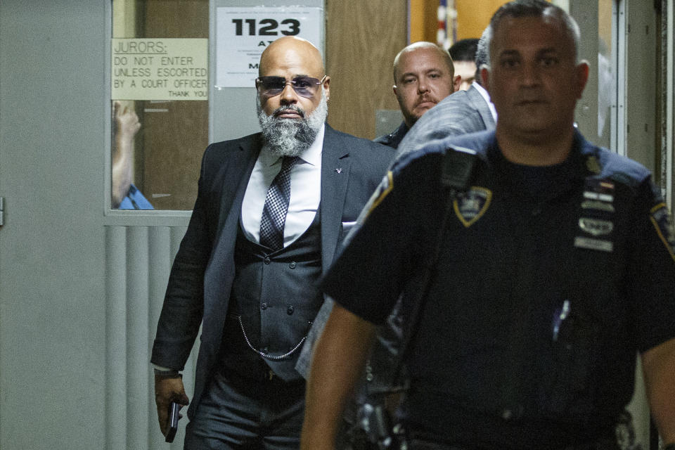 Steven Lopez, left, exits the courtroom following a hearing at the Supreme court, Monday, July 25, 2022, in New York. Lopez, a co-defendant of the so-called Central Park Five, whose convictions in a notorious 1989 rape of a jogger were thrown out more than a decade later, had his conviction on a related charge overturned Monday. Lopez was exonerated in response to requests by both Lopez’s attorney and prosecutors. (AP Photo/Eduardo Munoz Alvarez)