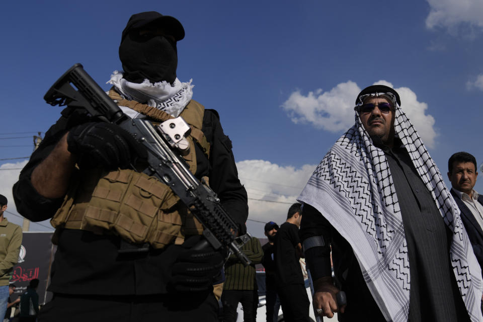 Members of an Iraqi Shiite militant group attend the funeral of a fighter with the Kataib Hezbollah, who was killed in a U.S. airstrike, in Baghdad, Iraq, Thursday, Jan. 25, 2024. (AP Photo/Hadi Mizban)