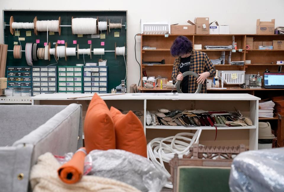 E-commerce manager Julian Bernal works to fill an order at Fabric Farms, a longtime fabric store and upholsterer in Hilliard.