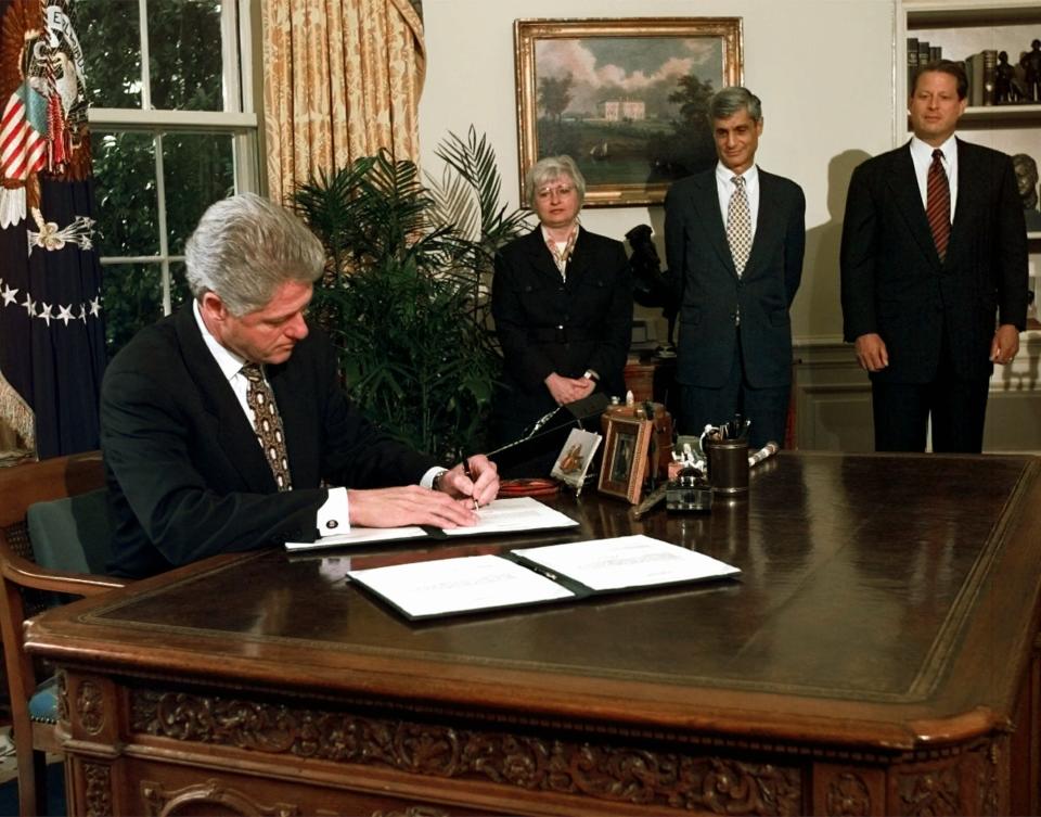 FILE - President Bill Clinton vetoes portions of the federal budget and tax-cut law in the Oval Office of the White House Aug. 11, 1997, as Vice President Al Gore, far right, Treasury Secretary Robert Rubin and Council of Economic Advisers Chairman Janet Yellen look on. (AP Photo/Ruth Fremson, File)