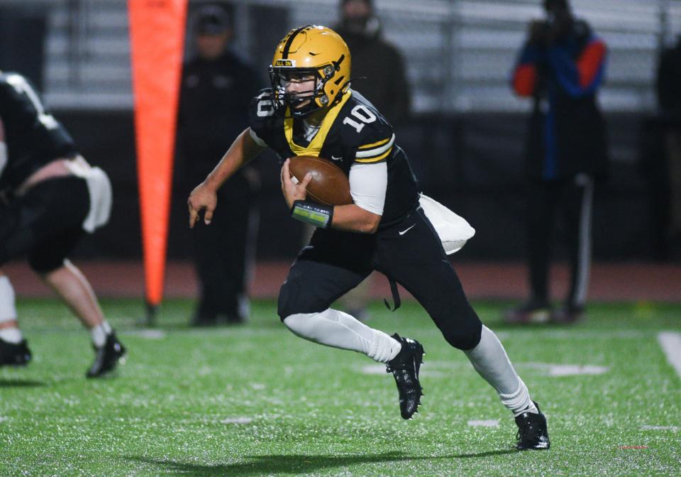 Central Bucks West quarterback Cooper Taylor picks up yardage against Cheltenham in a District One Class 6A playoff game.