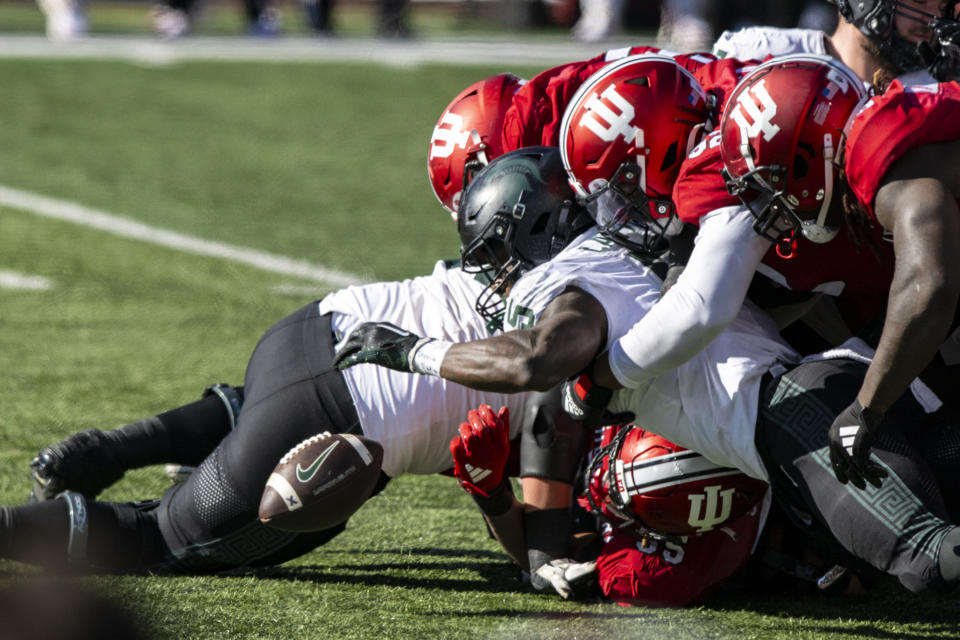 Michigan State running back Nathan Carter (5) reaches out for the ball after a fumble during an NCAA college football game against Indiana, Saturday, Nov. 18, 2023, in Bloomington, Ind. (AP Photo/Doug McSchooler)