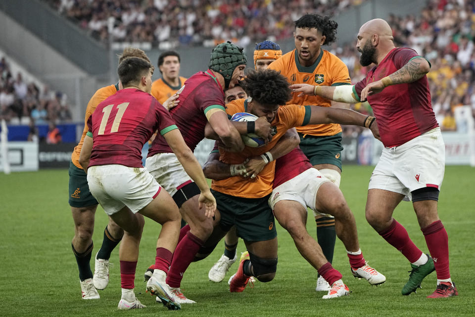 Australia's Rob Valetini is tackled during the Rugby World Cup Pool C match between Australia and Portugal at the Stade Geoffroy Guichard in Saint-Etienne, France, Sunday, Oct. 1, 2023. (AP Photo/Laurent Cipriani)