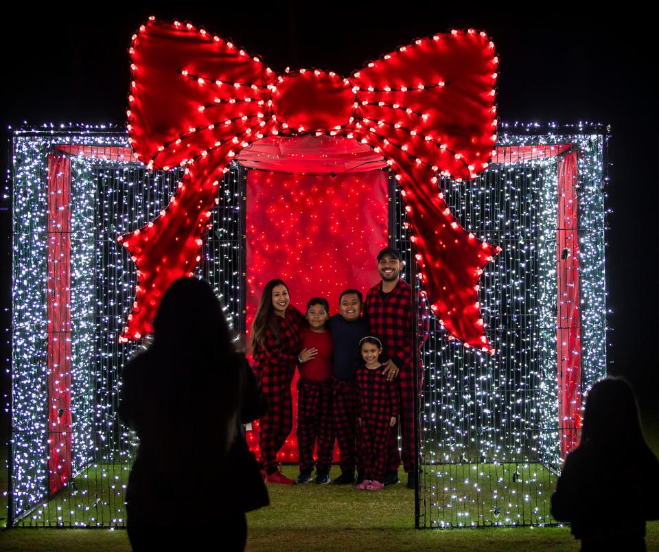 The Vargas family poses for a photo together during the Magic of Lights holiday display at the Empire Polo Club in Indio, Calif., Thursday, Nov. 16, 2023.