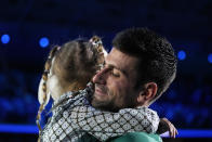 Serbia's Novak Djokovic celebrates with his daughter after defeating Norway's Casper Ruud 7-5, 6-3, in their singles final tennis match of the ATP World Tour Finals at the Pala Alpitour, in Turin, Italy, Sunday, Nov. 20, 2022. (AP Photo/Antonio Calanni)