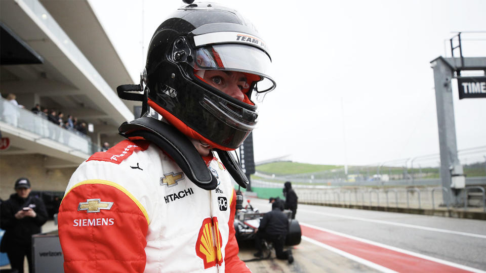 Scott McLaughlin with the helmet on and putting the gloves on as he gets ready for his IndyCar time trial.