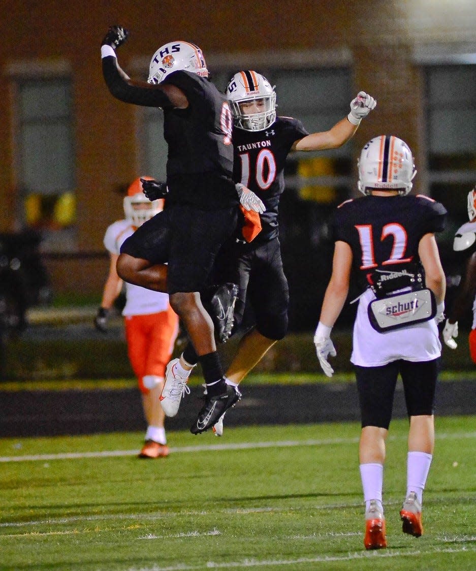 The Taunton high football team celebrates a touchdown against Oilver Ames on Oct. 14, 2021.