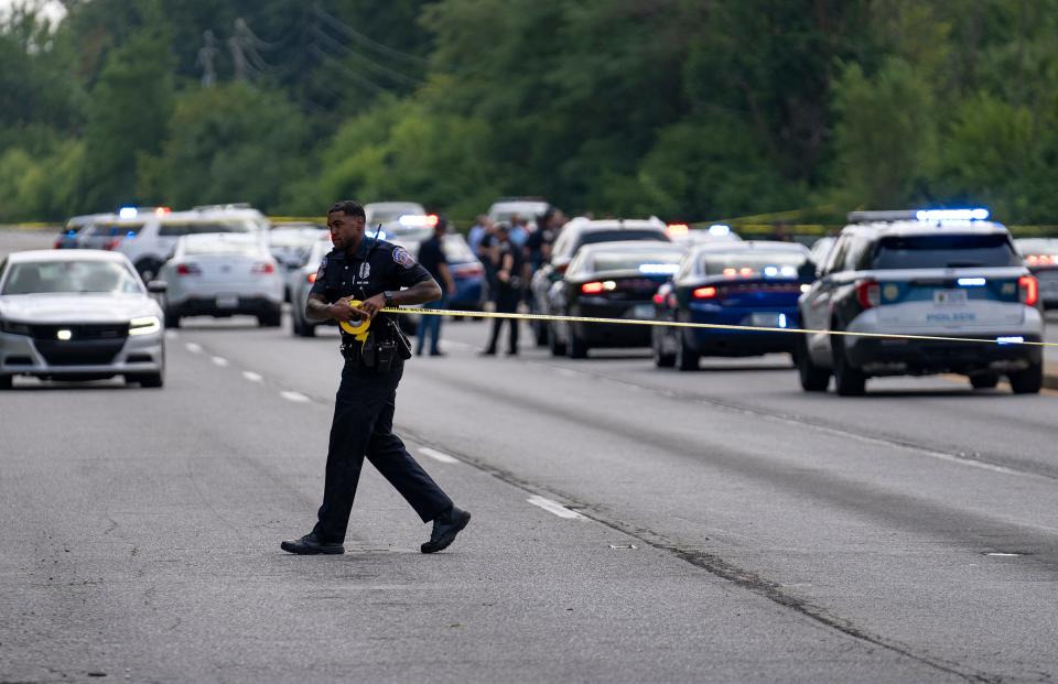 Indiana State Police officers and other investigators work the scene where a stolen vehicle pursuit ended  with a person shot Friday, Aug. 18, 2023, on Raymond Street, west of the intersection with Emerson Avenue, in Indianapolis. ISP confirmed that a Beech Grove officer fired their weapon and the person fleeing in the stolen vehicle had a gunshot wound, as of 2 p.m. The suspect was in stable condition at the time.