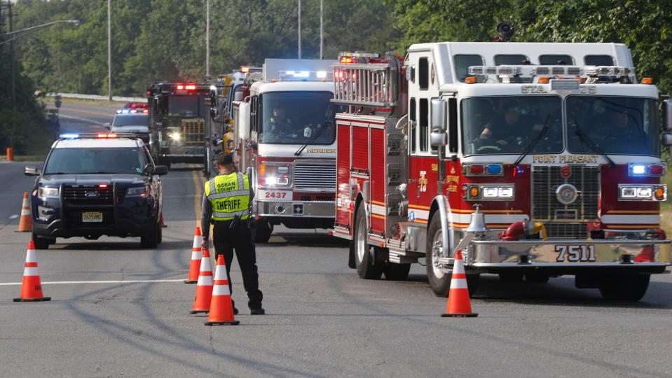 Fire vehicles roll through East Commodore Boulevard and Cedar Swamp Road in Jackson Township Tuesday evening, June 6, 2023, enroute to a staging area for a nearby brush fire.