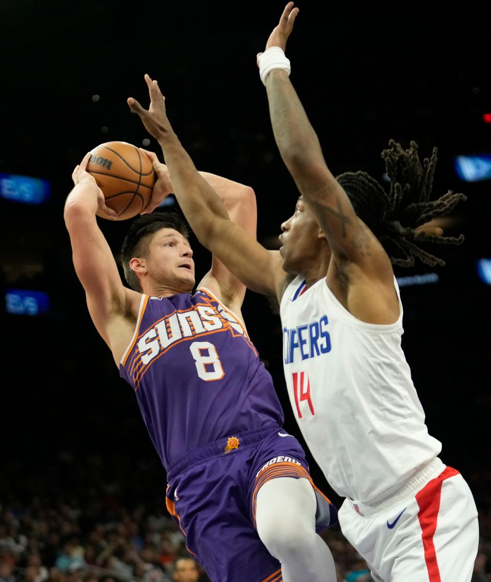 Phoenix Suns guard Grayson Allen (8) looks to pass against LA Clippers guard Terance Mann (14) during the fourth quarter at Footprint Center in Phoenix on April 9, 2024.