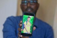 Former deputy director of NISA Abdisalan Guled holds a cellphone in Mogadishu