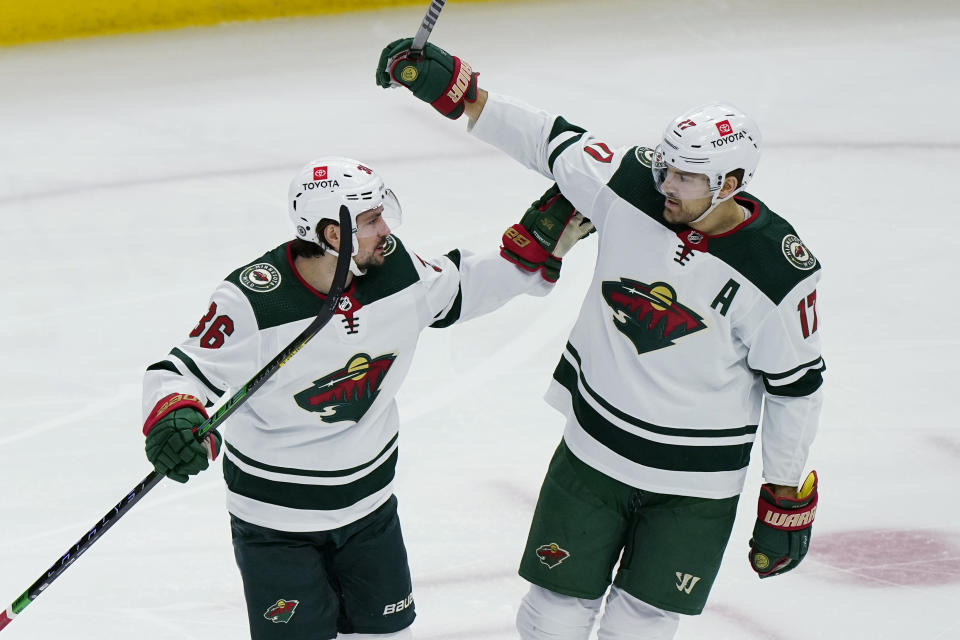 Minnesota Wild left wing Marcus Foligno, right, celebrates with right wing Mats Zuccarello after scoring a goal against the Chicago Blackhawks during the first period of an NHL hockey game in Chicago, Friday, Jan. 21, 2022. (AP Photo/Nam Y. Huh)