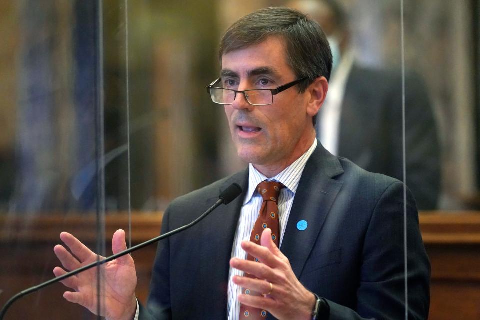 Sen. Briggs Hopson, R-Vicksburg, stands behind the safety barrier and presents a bill at the Capitol in Jackson, Miss., Tuesday, Feb. 9, 2021. Lawmakers in both chambers spent the day reviewing and debating legislation that originated in their own house.