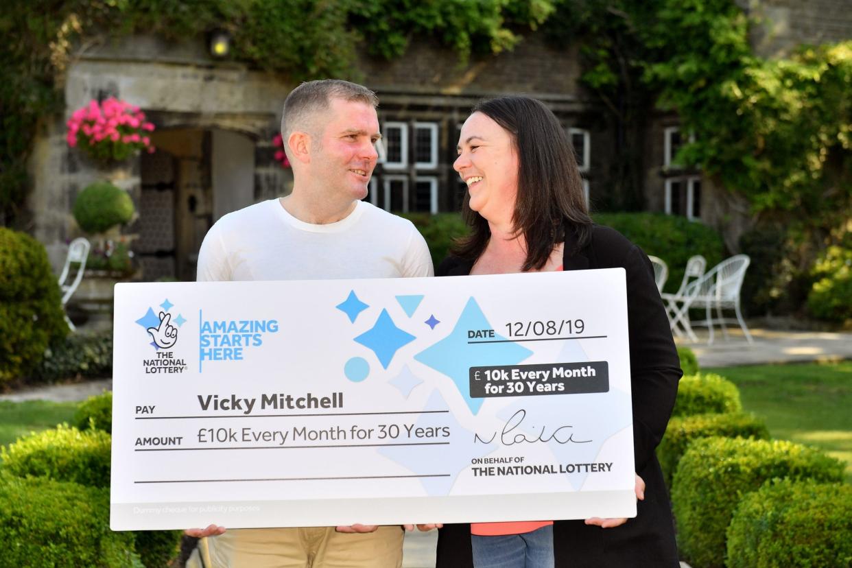 Vicky Mitchell and partner Adam Fry celebrate winning the National Lottery's Set For Life draw at the Holdsworth Hotel in Halifax (PA)