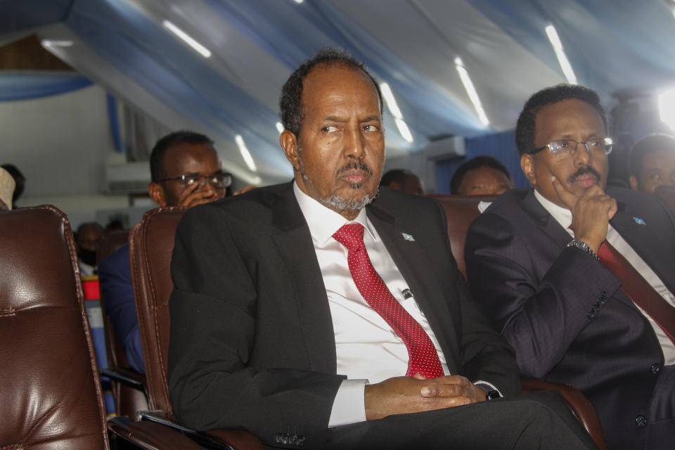 Presidential candidates former president Hassan Sheikh Mohamud, center, and incumbent leader Mohamed Abdullahi Mohamed, right, attend a voting session for the presidential election at the Halane military camp which is protected by African Union peacekeepers, in Mogadishu, Somalia Sunday, May 15, 2022. Legislators in Somalia are meeting Sunday to elect the country's president in the capital, Mogadishu, which is under lockdown measures aimed at preventing deadly militant attacks. (AP Photo/Farah Abdi Warsameh)