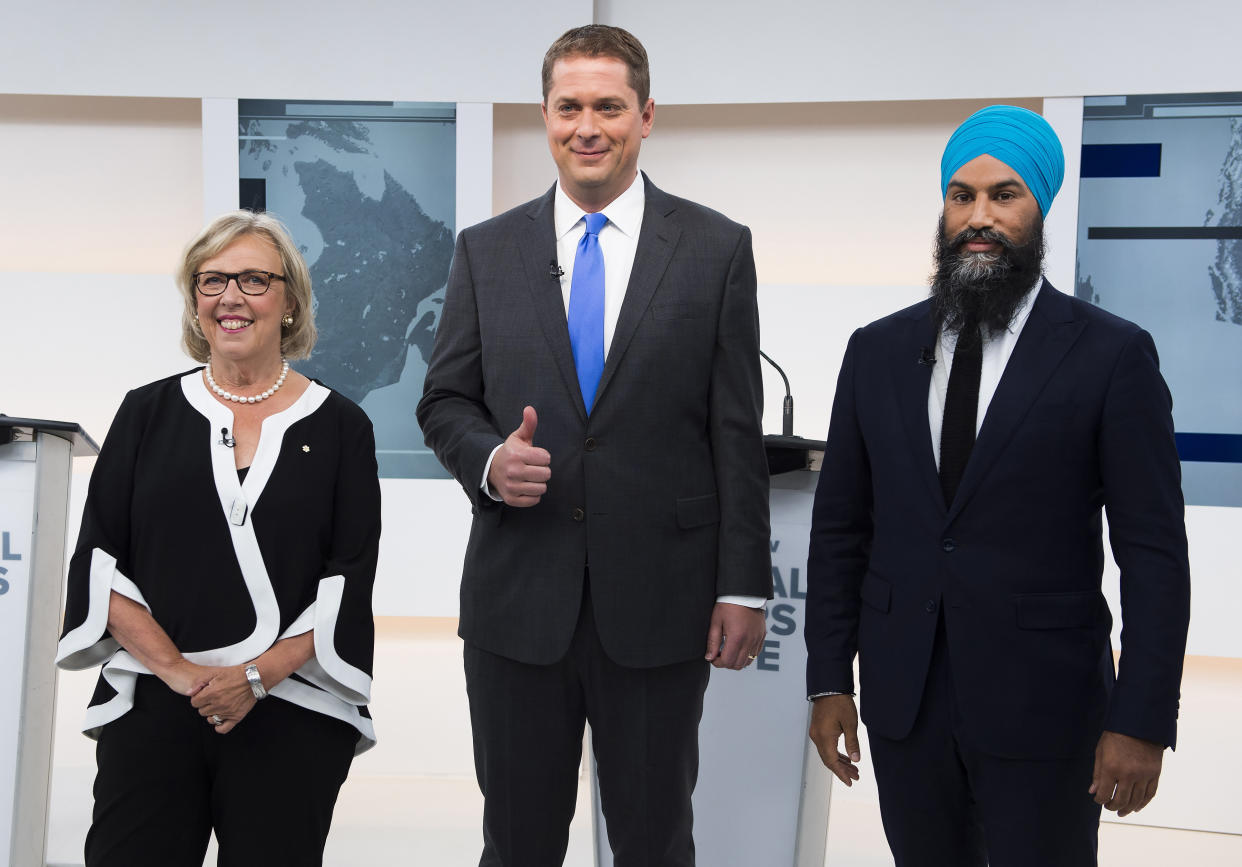 Green Leader Elizabeth May, left, Conservative Leader Andrew Scheer, center, and NDP Leader Jagmeet Singh pose for a photograph before the Maclean's/Citytv National Leaders Debate in Toronto, on Thursday, Sept. 12, 2019. (Frank Gunn/The Canadian Press via AP)