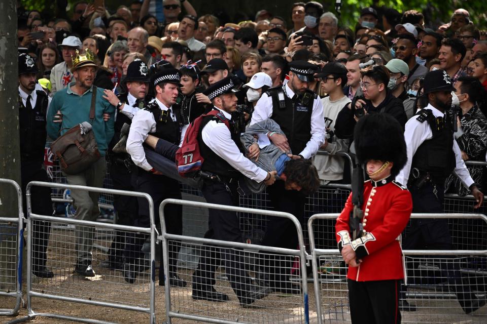 Police escort protesters away from the Mall during the Queen's Birthday Parade (AFP via Getty Images)