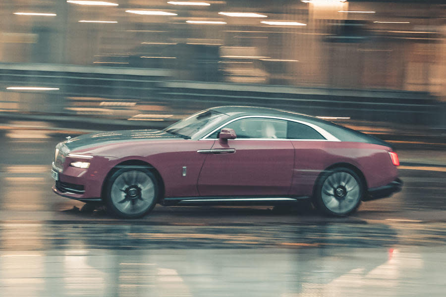 Rolls-Royce Spectre driving through city – side