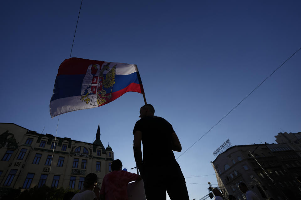 A man waves a flag combined of Russian and Serbian colours as he attends a protest against pollution and the exploitation of a lithium mine in the country, in Belgrade, Serbia, Saturday, Aug. 10, 2024. Thousands were gathering Saturday at a rally against lithium mining in Serbia despite government warnings of alleged planned unrest designed to topple the government of populist President Aleksandar Vucic. (AP Photo/Darko Vojinovic)