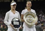 Eugenie Bouchard (L) of Canada holds the runner up trophy after being defeated by Petra Kvitova (R) of Czech Republic, holding the winner's trophy, the Venus Rosewater Dish, at their women's singles final tennis match at the Wimbledon Tennis Championships in London July 5, 2014. REUTERS/Toby Melville