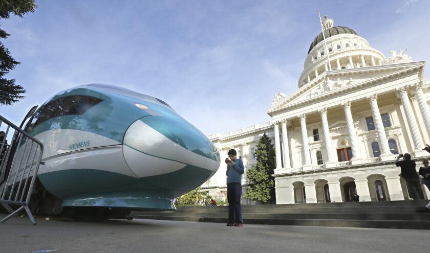 FILE — In this Feb. 26, 2015, file photo, a full-scale mock-up of a high-speed train is displayed at the Capitol in Sacramento, Calif. Lawmakers and the Newsom administration are still trying to reach agreement on whether to give the project $4.2 billion that's left in the bond fund voters approved for high-speed rail in 2008. Rail officials say the need it to continue construction beyond next summer, but some state lawmakers want more oversight of the project before releasing it. (AP Photo/Rich Pedroncelli, File)