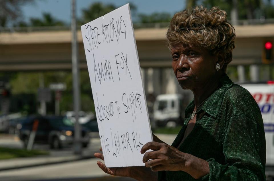 Fort Myers resident Hester Young holds a signs while protesting in downtown Fort Myers Friday afternoon, March 15, 2024. Members of the Lee County NAACP held a rally in front of the office of the state attorney to protest the handling of the Fort Myers Police Department fatal shooting of Christopher Jordan on December 1, 2023.